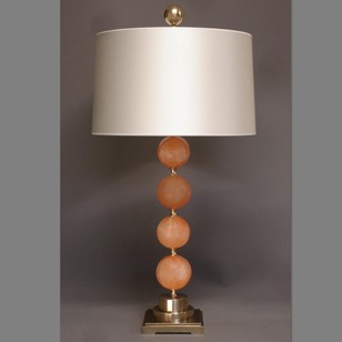 Single orange Satin Spar spheres table lamp.